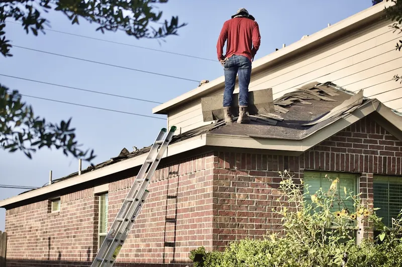 Professional roofer working on a residential roof in Constance